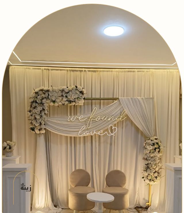 Photo corner with neon lighting and white florals for an engagement — Zaina Events Abu Dhabi