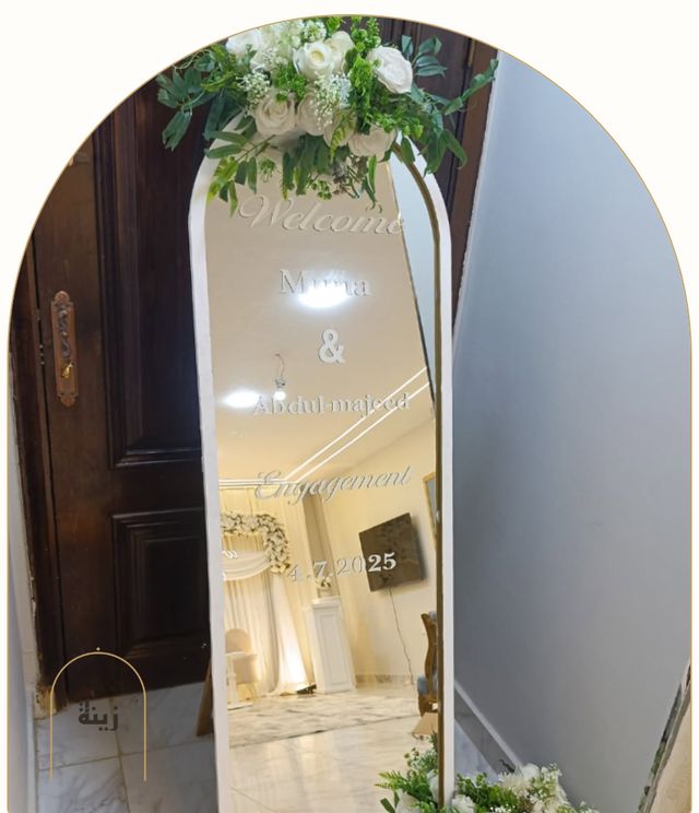 Gilded welcome mirror with white florals for an engagement — Zaina Events Abu Dhabi
