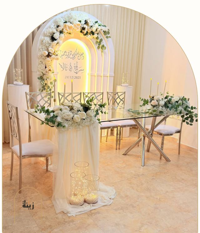 Lit arch with the couple’s names and a glass table for a katb ketab — Zaina Events Abu Dhabi