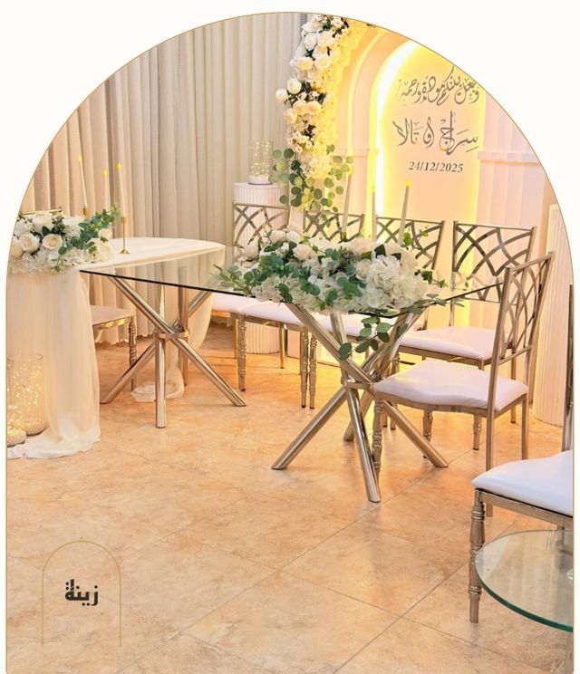 Glass signing table with white florals and silver chairs — Zaina Events Abu Dhabi
