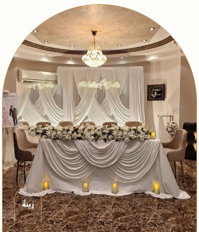 Sweetheart table with cascading white drapes, florals and candles — Zaina Events Abu Dhabi